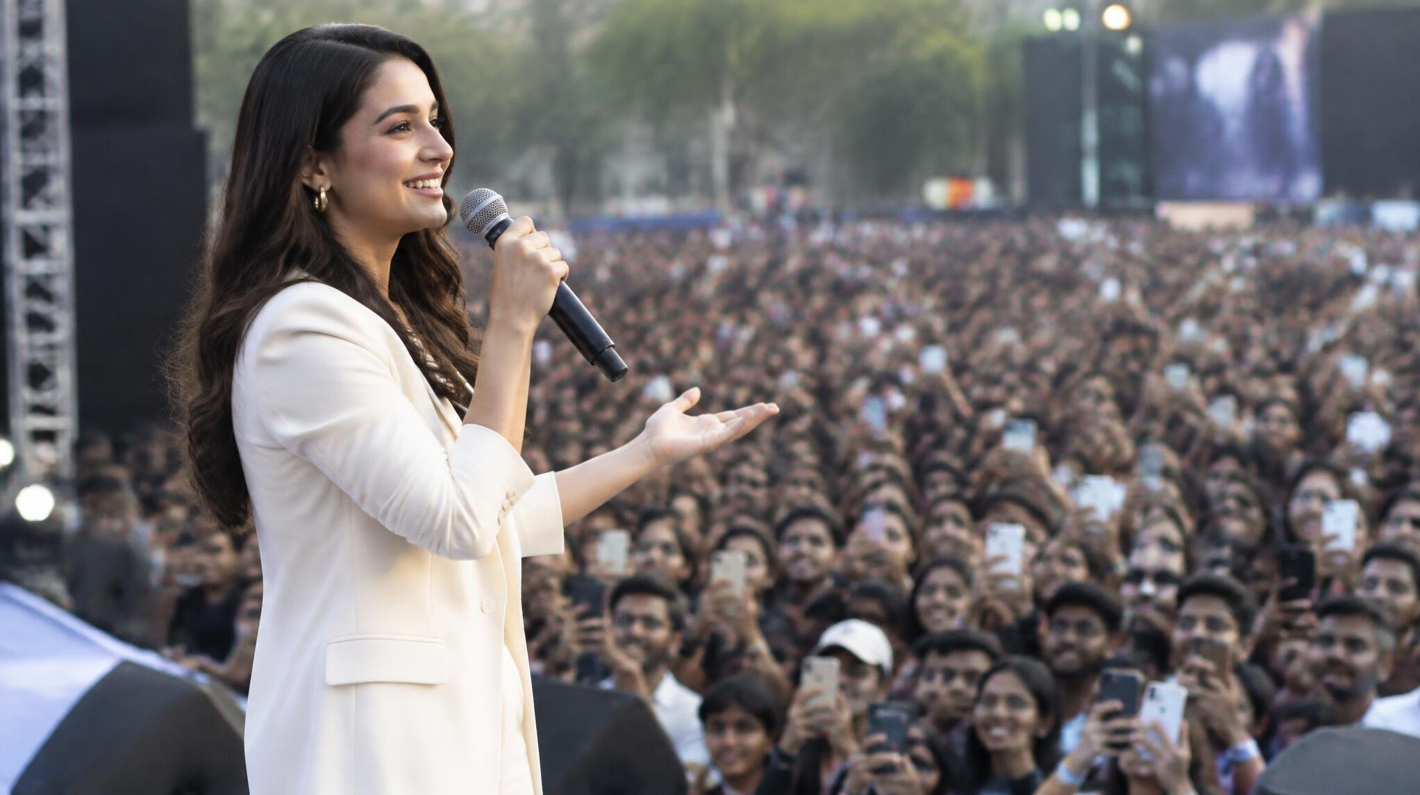 celebrity speaking to large crowd